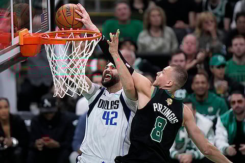 Kristaps Porzingis blocks a shot by Maxi Kleber